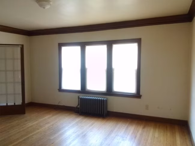 Empty room with windows and radiator